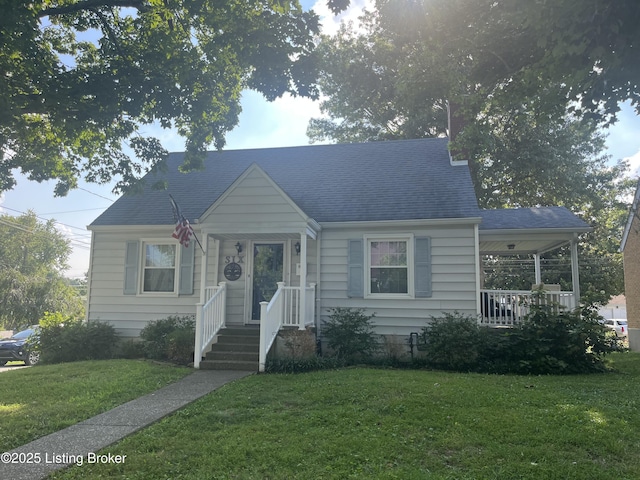 bungalow-style house with roof with shingles and a front yard