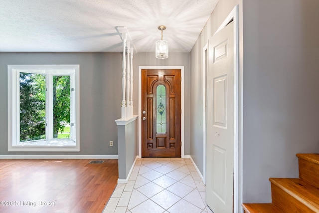 10207 El Coco Ct, Louisville, KY 40291 - foyer entrance featuring a chandelier, stairs, and light tile patterned flooring
