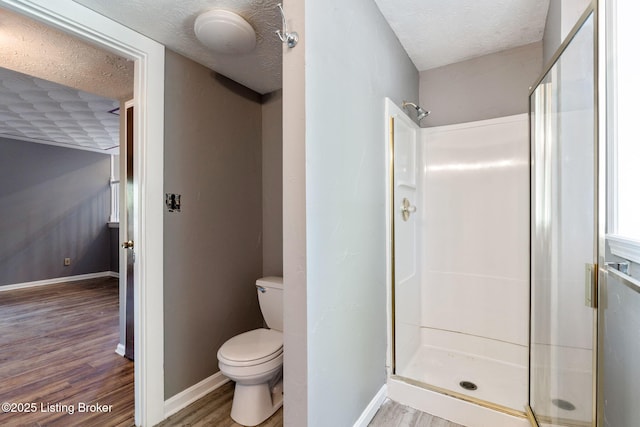 10207 El Coco Ct, Louisville, KY 40291 - full bathroom featuring wood finished floors, a stall shower, and a textured ceiling