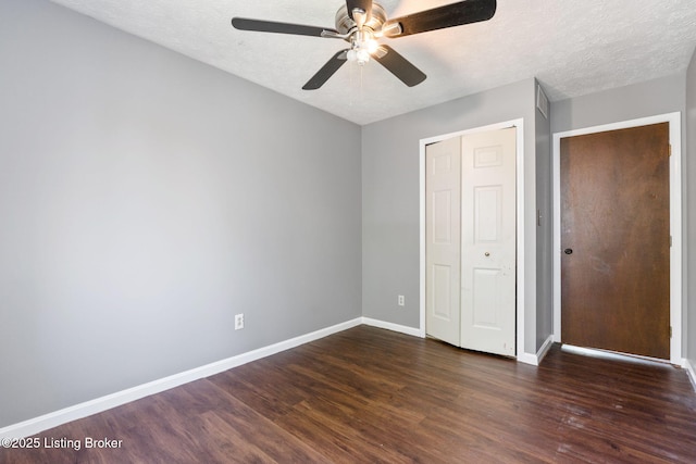 10207 El Coco Ct, Louisville, KY 40291 - unfurnished bedroom with dark wood-style flooring, a closet, a textured ceiling, and a ceiling fan