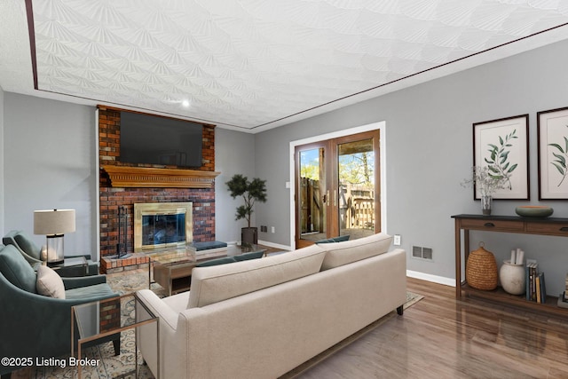 10207 El Coco Ct, Louisville, KY 40291 - living area featuring a brick fireplace and wood finished floors
