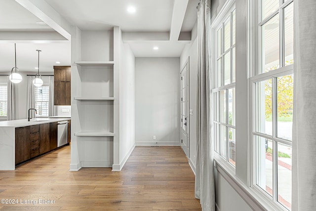 interior space featuring baseboards, recessed lighting, a sink, and light wood-style floors