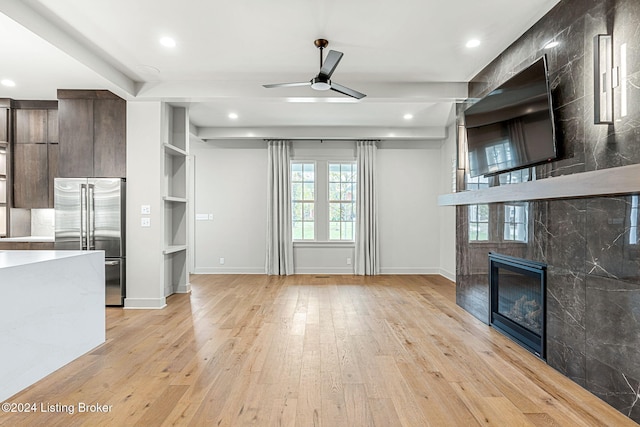 unfurnished living room featuring a tile fireplace, recessed lighting, a ceiling fan, baseboards, and light wood finished floors