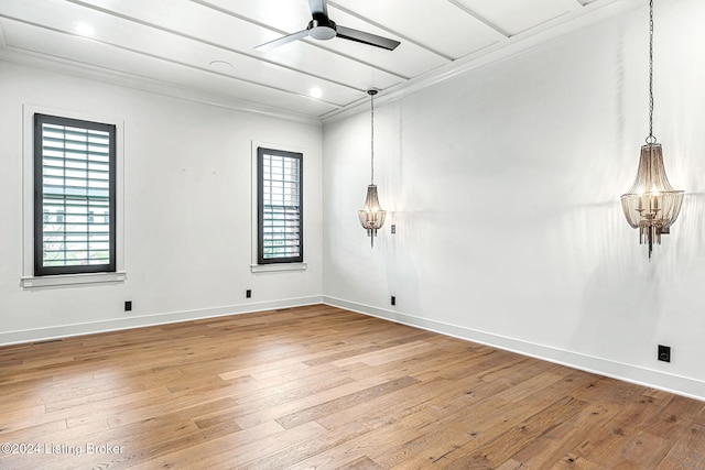 spare room featuring a healthy amount of sunlight, ceiling fan, baseboards, and wood finished floors