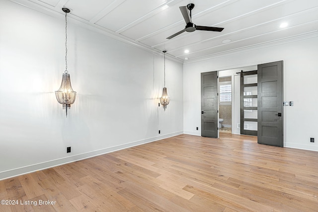 unfurnished bedroom featuring a barn door, ensuite bath, light wood-style flooring, and baseboards