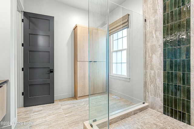 bathroom with walk in shower and visible vents