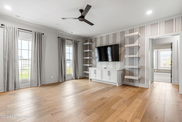 unfurnished living room featuring light wood-style floors, visible vents, and a wealth of natural light