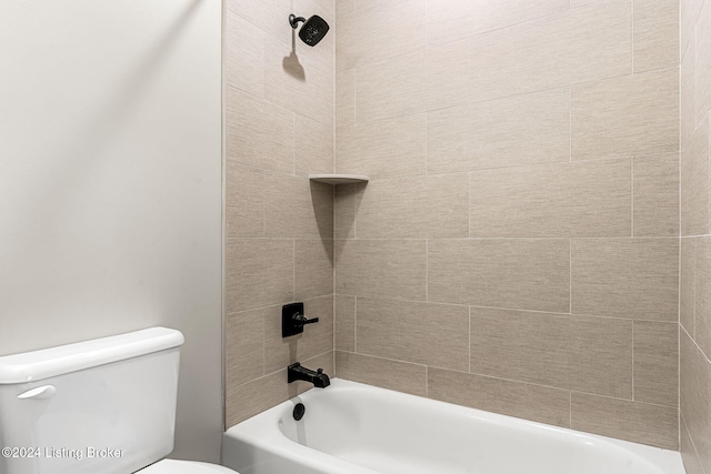 bathroom featuring tub / shower combination and toilet