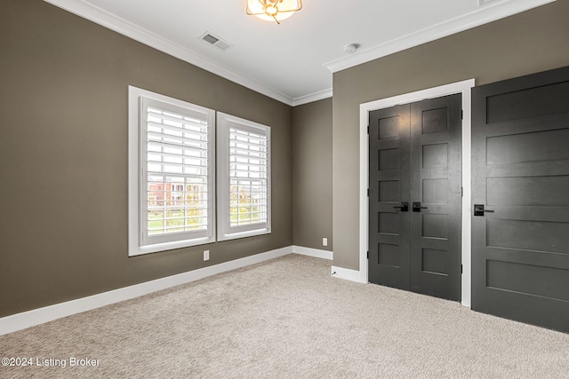 interior space featuring baseboards, visible vents, light colored carpet, and ornamental molding