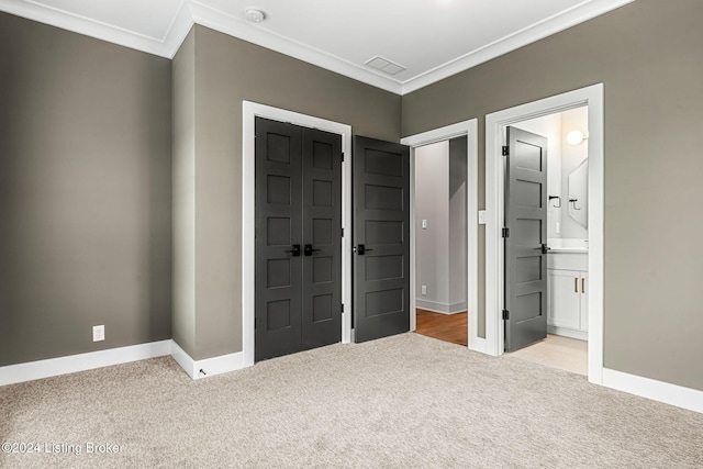 unfurnished bedroom featuring crown molding, baseboards, visible vents, and light colored carpet