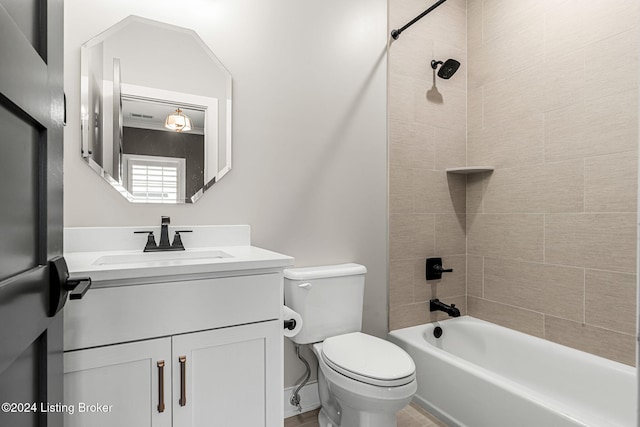 bathroom featuring toilet, vanity, and shower / bathing tub combination