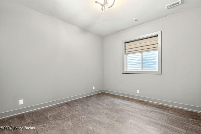 spare room featuring visible vents and baseboards