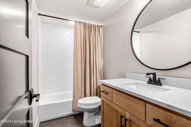 bathroom featuring shower / bath combination with curtain, vanity, toilet, and wood finished floors