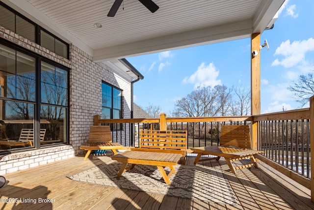 wooden terrace featuring a ceiling fan