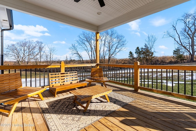 deck featuring a ceiling fan and a water view