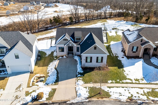 snowy aerial view featuring a residential view