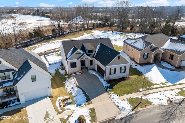 snowy aerial view featuring a residential view