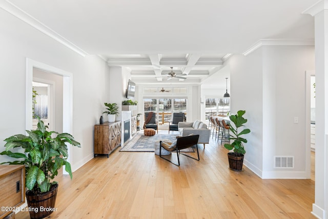 living area featuring light wood finished floors, coffered ceiling, visible vents, and baseboards