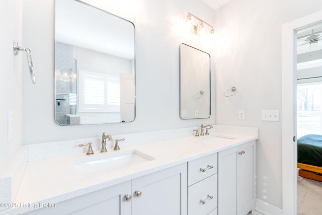 ensuite bathroom featuring ensuite bathroom, a sink, and a wealth of natural light