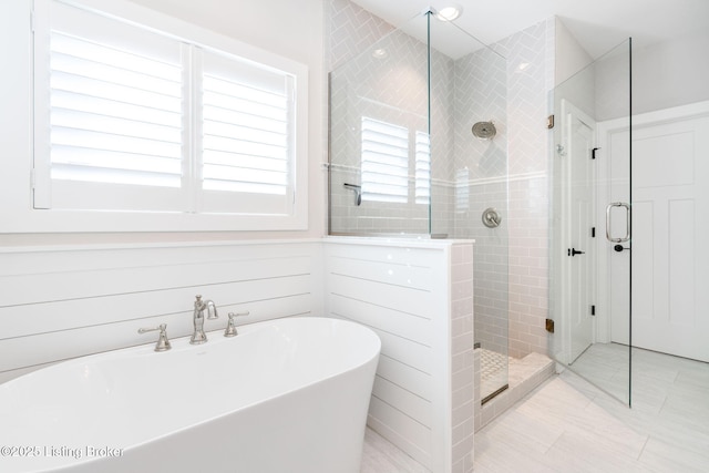 full bathroom featuring a soaking tub and tiled shower