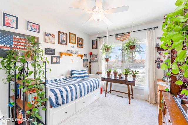 bedroom featuring visible vents, a ceiling fan, and light colored carpet