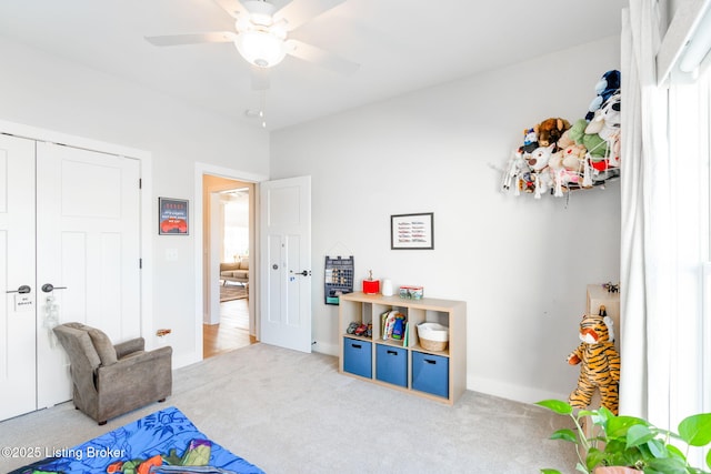 interior space featuring a closet, carpet, a ceiling fan, and baseboards