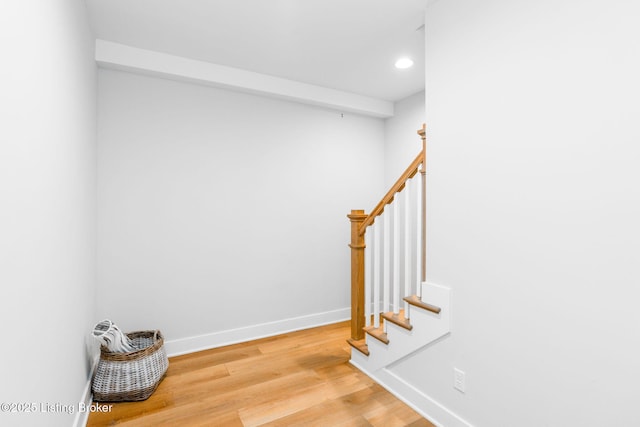 staircase with recessed lighting, baseboards, and wood finished floors