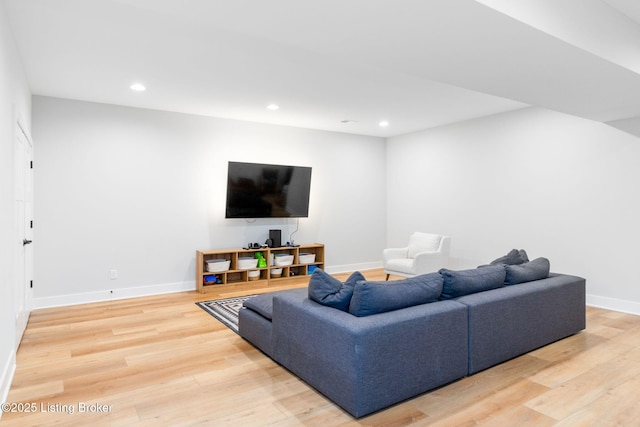 living room featuring baseboards, wood finished floors, and recessed lighting