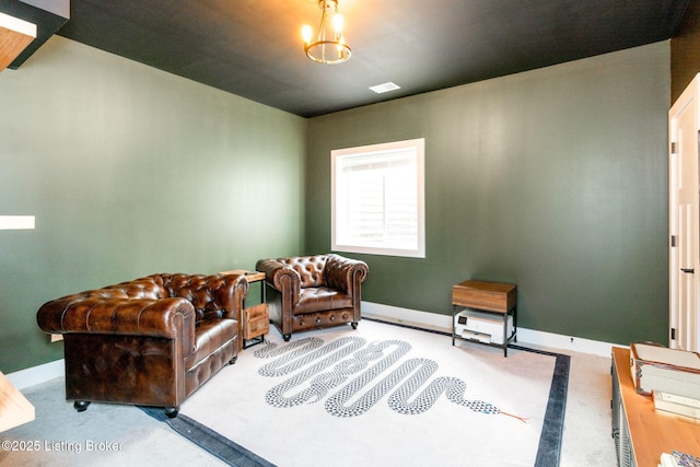 living area featuring carpet, visible vents, and baseboards