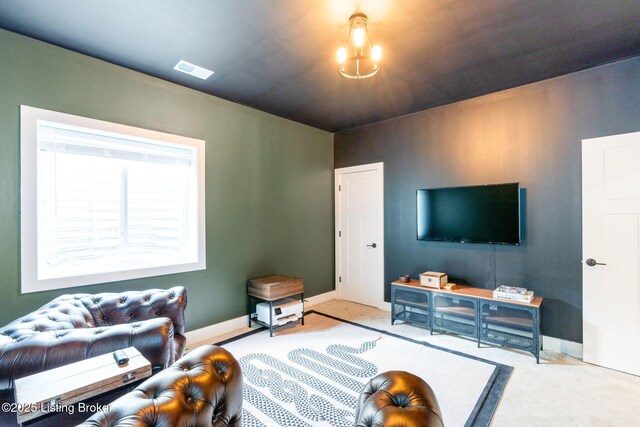 living area with baseboards, visible vents, and carpet flooring