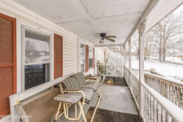 snow covered patio with a porch and a ceiling fan