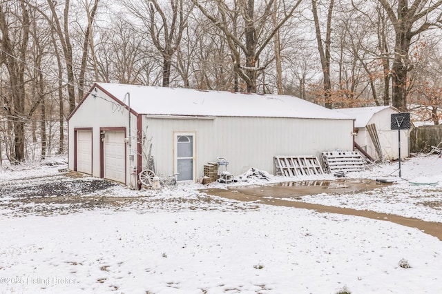 snow covered garage with a garage