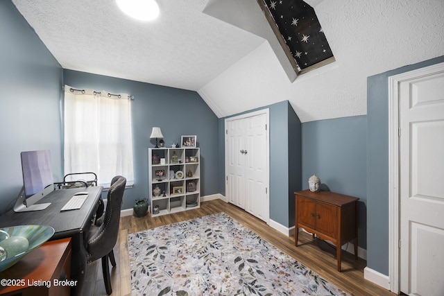 office space with lofted ceiling, dark wood finished floors, a textured ceiling, and baseboards