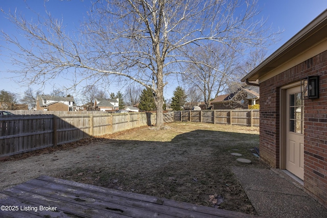 view of yard with a fenced backyard and a residential view