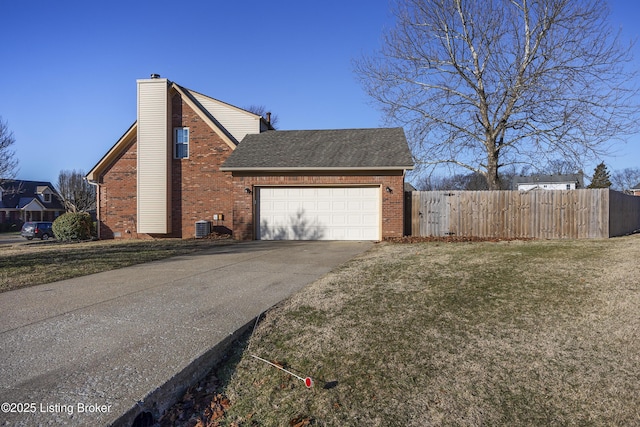 view of side of property with concrete driveway, brick siding, a chimney, and fence