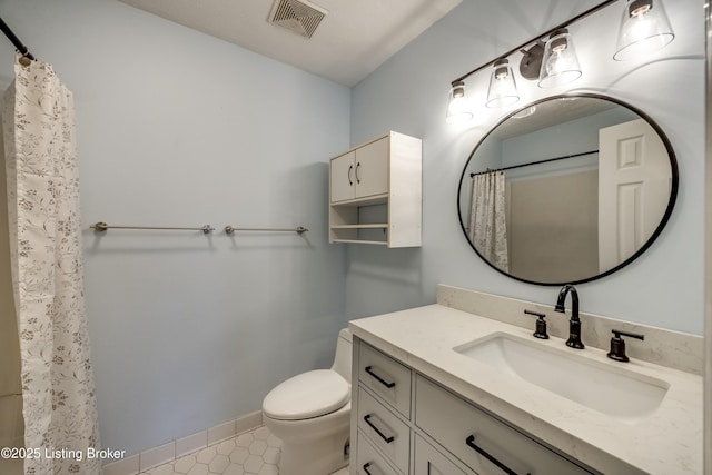 bathroom featuring baseboards, visible vents, toilet, tile patterned floors, and vanity