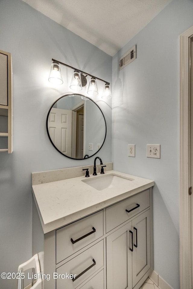 bathroom with visible vents and vanity