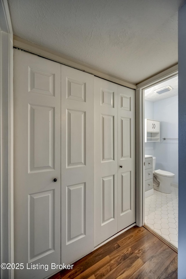 details featuring a textured ceiling, visible vents, and wood finished floors