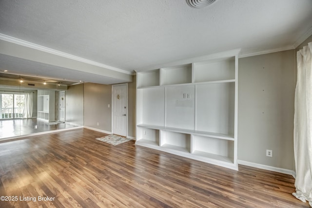 unfurnished living room featuring baseboards, a textured ceiling, ornamental molding, and wood finished floors