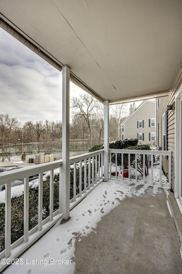 view of snow covered back of property