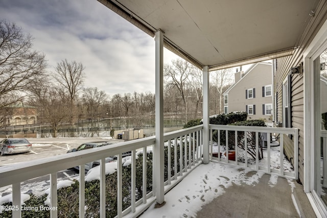 view of snow covered back of property