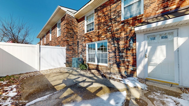 exterior space with cooling unit and fence