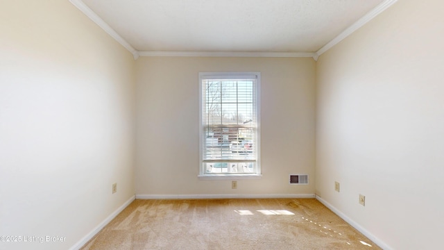 unfurnished room featuring crown molding, baseboards, visible vents, and light carpet