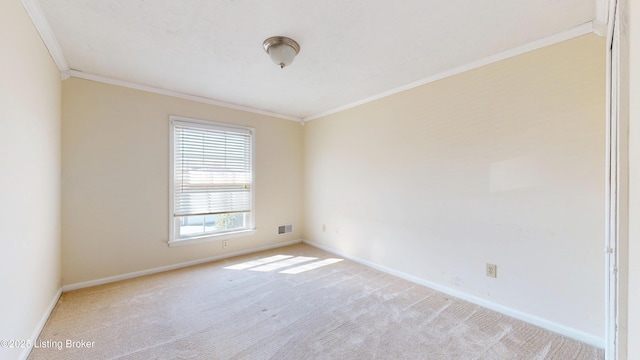 carpeted empty room featuring visible vents, baseboards, and ornamental molding