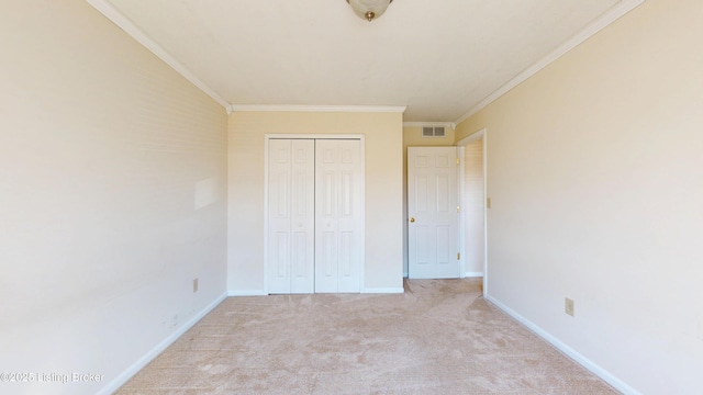 unfurnished bedroom with light colored carpet, visible vents, a closet, and ornamental molding