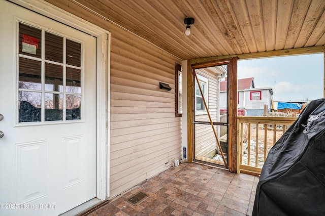 exterior space with wooden ceiling and visible vents