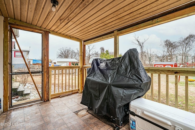 sunroom featuring plenty of natural light and wood ceiling