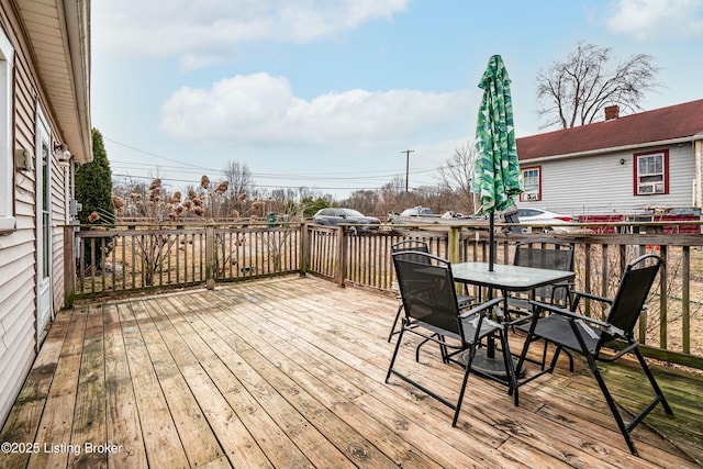 wooden terrace with outdoor dining space