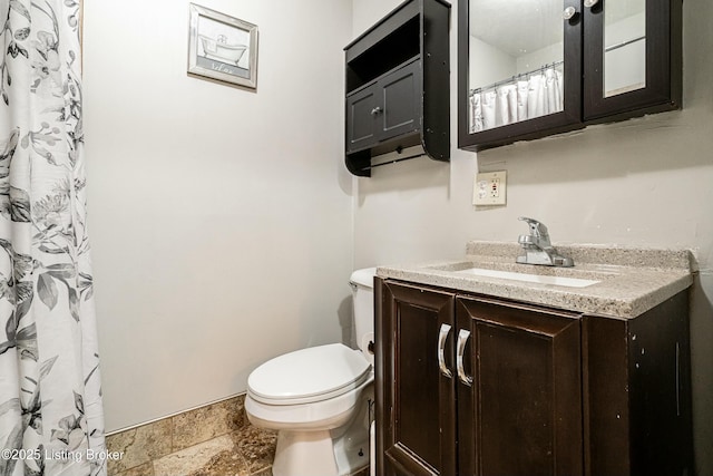 bathroom featuring toilet and vanity