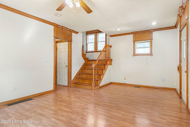 unfurnished room featuring a healthy amount of sunlight, light wood-style floors, and visible vents